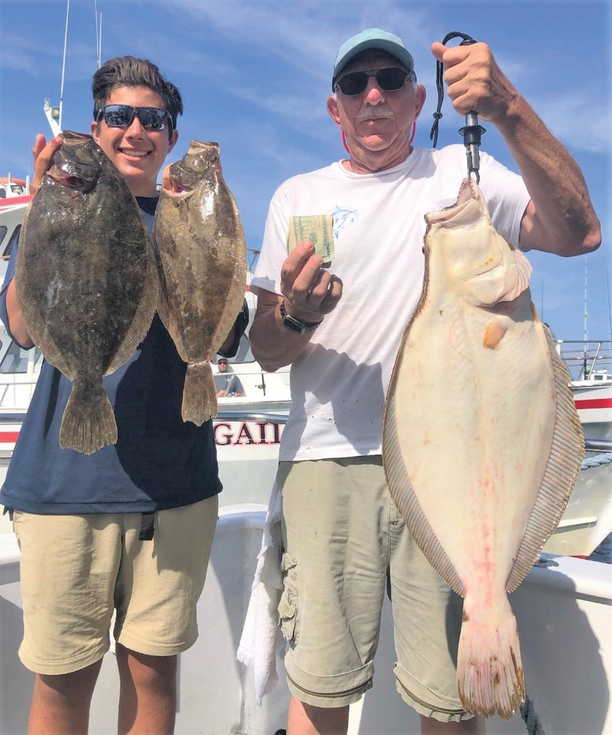 TOP PRIZE: Jack Guarnaccia with the 9.75-pound summer flounder he caught during the RI Saltwater Anglers Association fluke trip last weekend. Shown with his grandson Max Namba. (Submitted photos)